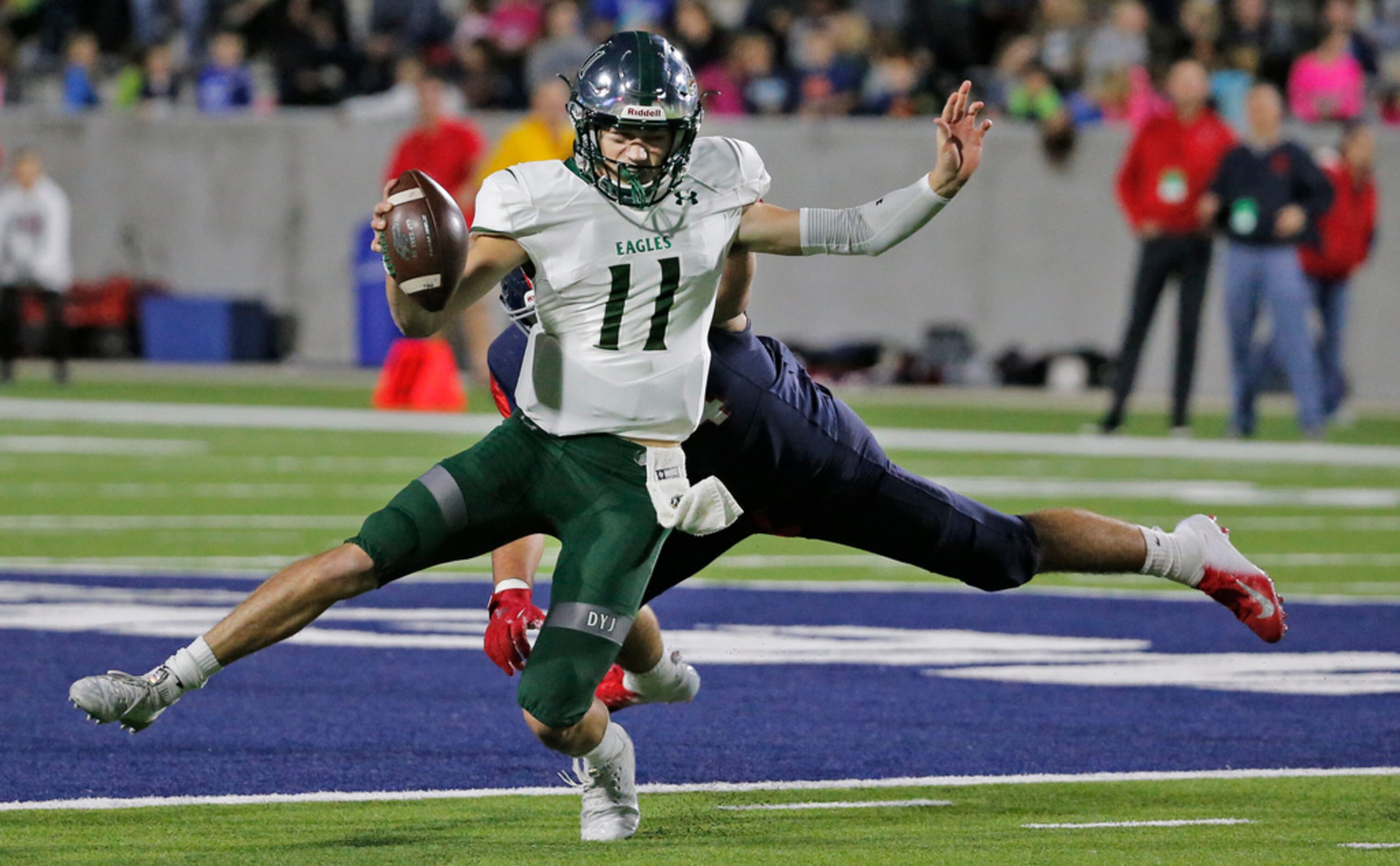 Prosper quarterback Keegan Shoemaker (11) scrambles away from pressure in the first quarter...