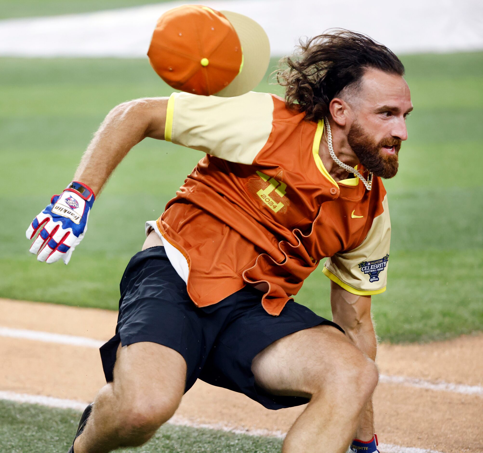 Dude Perfect’s Tyler Toney comes to his feet after stumbling over first base to end the MLB...