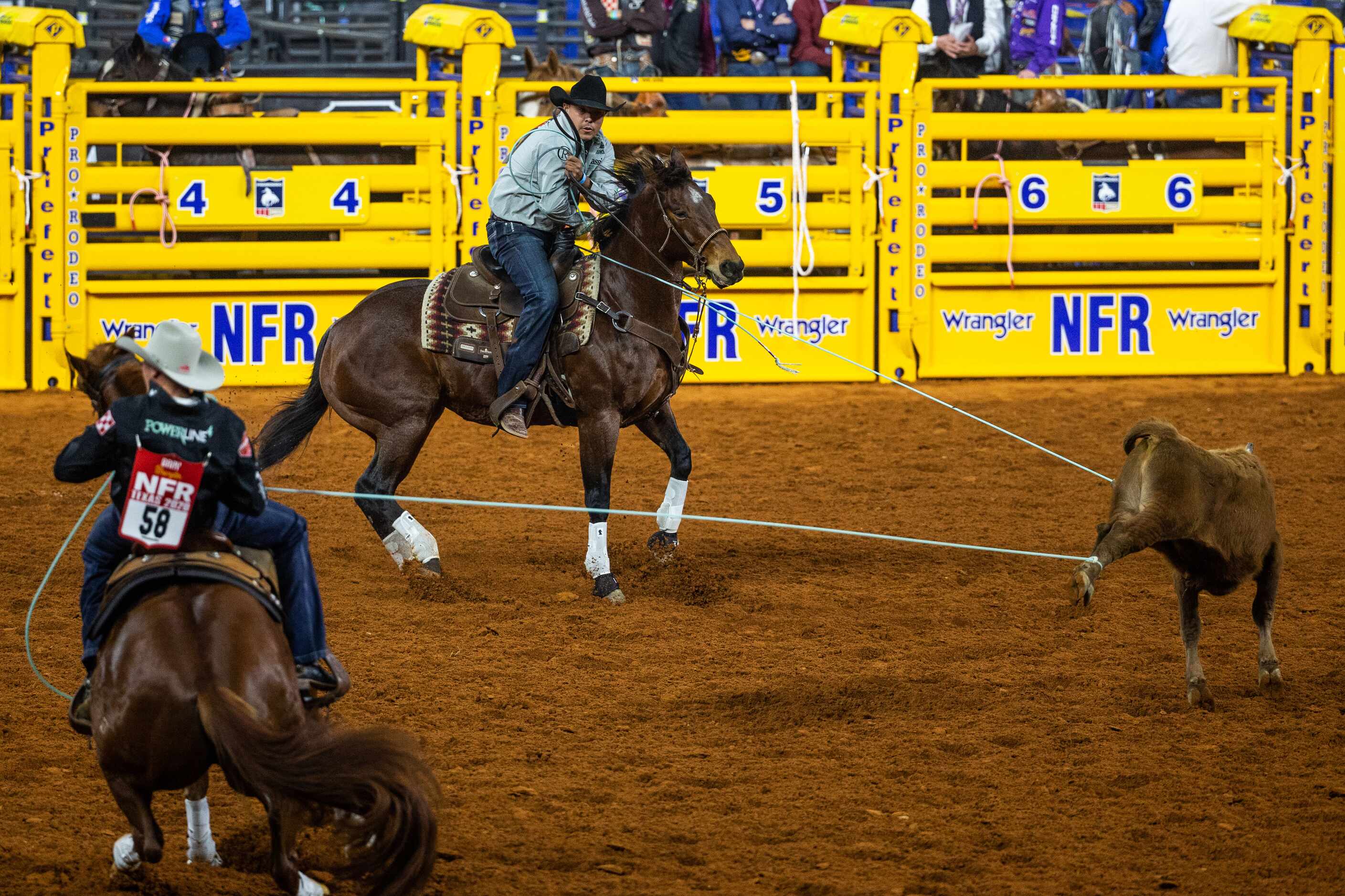 PRCA Team Roping contestants Paden Bray (left) and Erich Rogers compete during the opening...