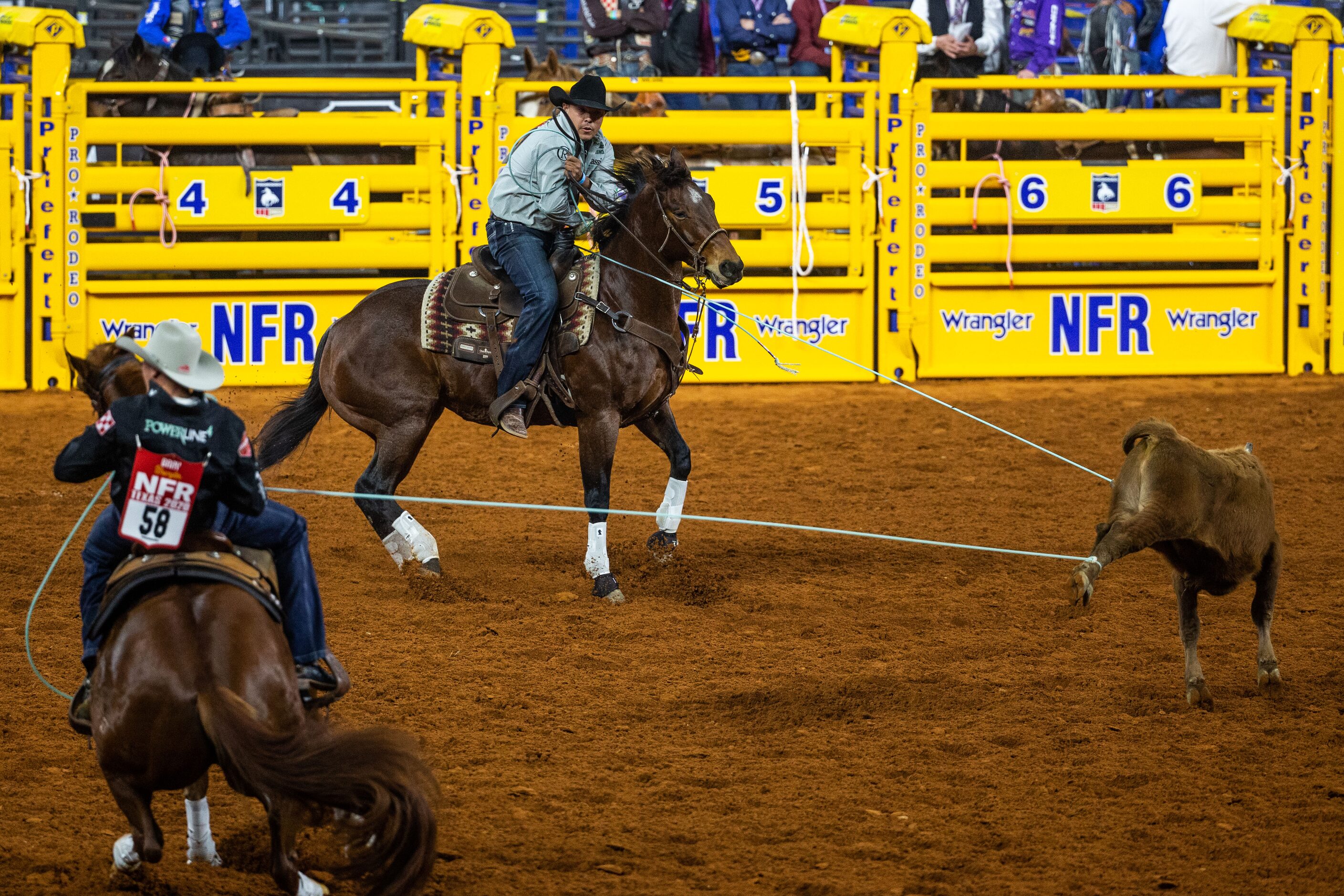 PRCA Team Roping contestants Paden Bray (left) and Erich Rogers compete during the opening...