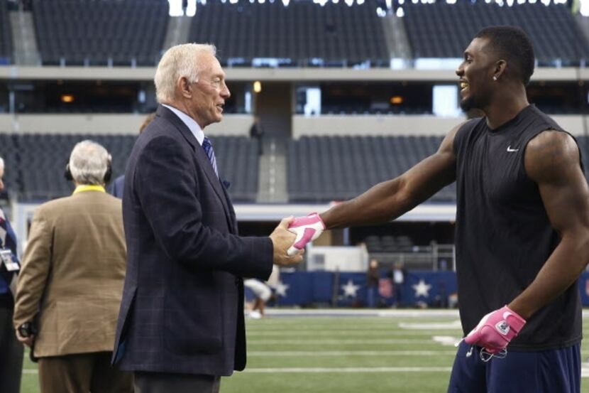 Dallas Cowboys owner Jerry Jones, left, and wide receiver Dez Bryant shake hands on the...