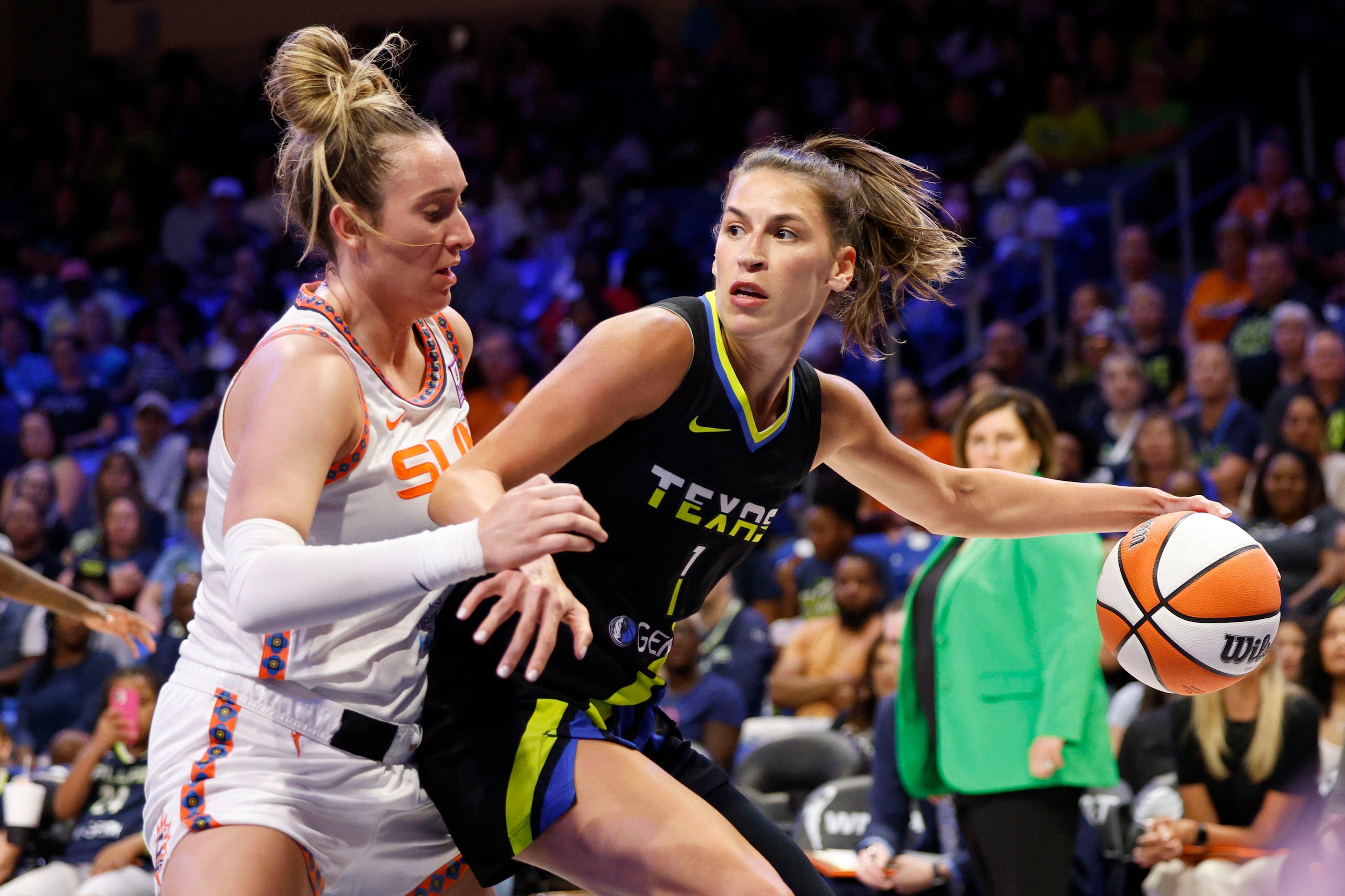 Dallas Wings guard Sevgi Uzun (1) tries to drive past Connecticut Sun guard Marina Mabrey...