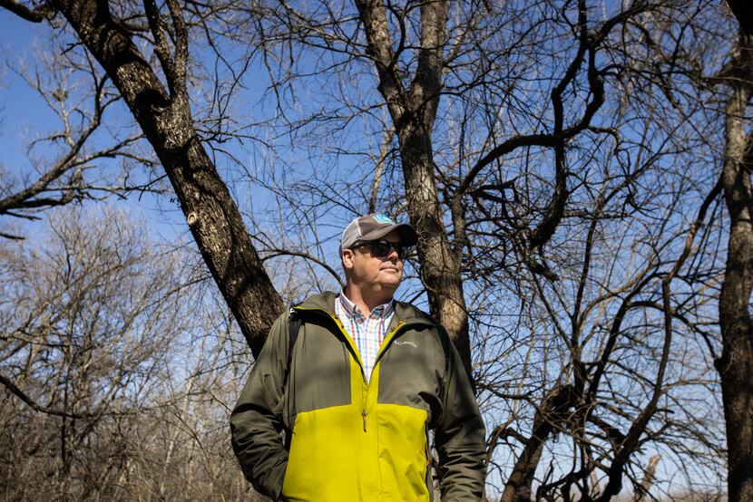 Texas master naturalist Ben Sandifer stands under a canopy of dormant trees in the Great...