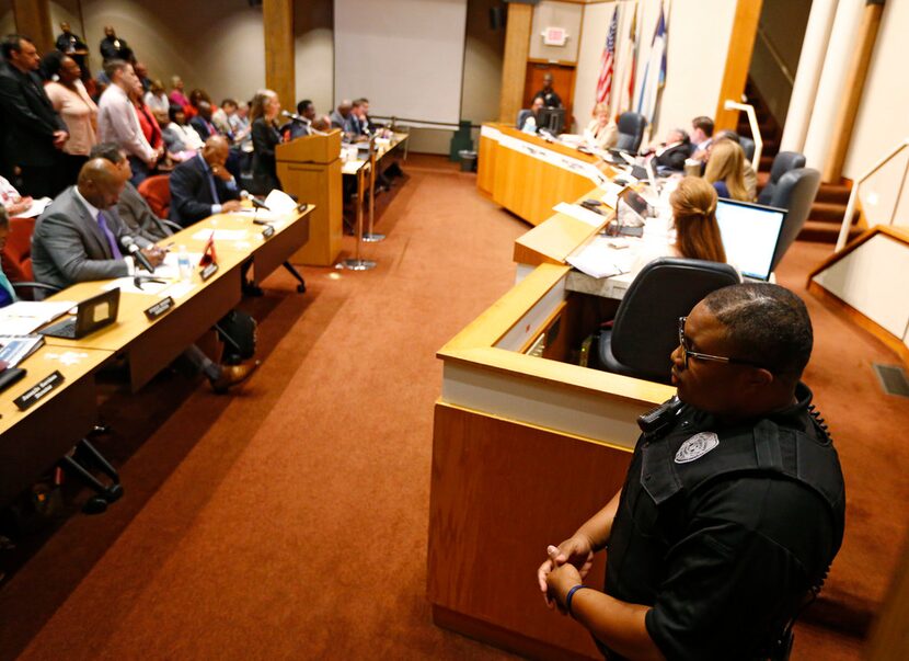 A Dallas County marshal stands guard at the county administration building in downtown...