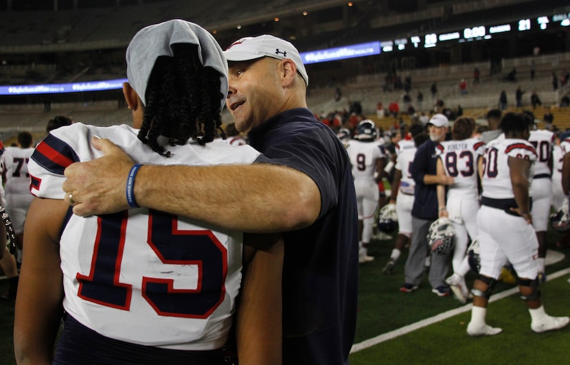 Denton Ryan quarterback Khalon Davis (15) receives words of encouragement from Raiders head...