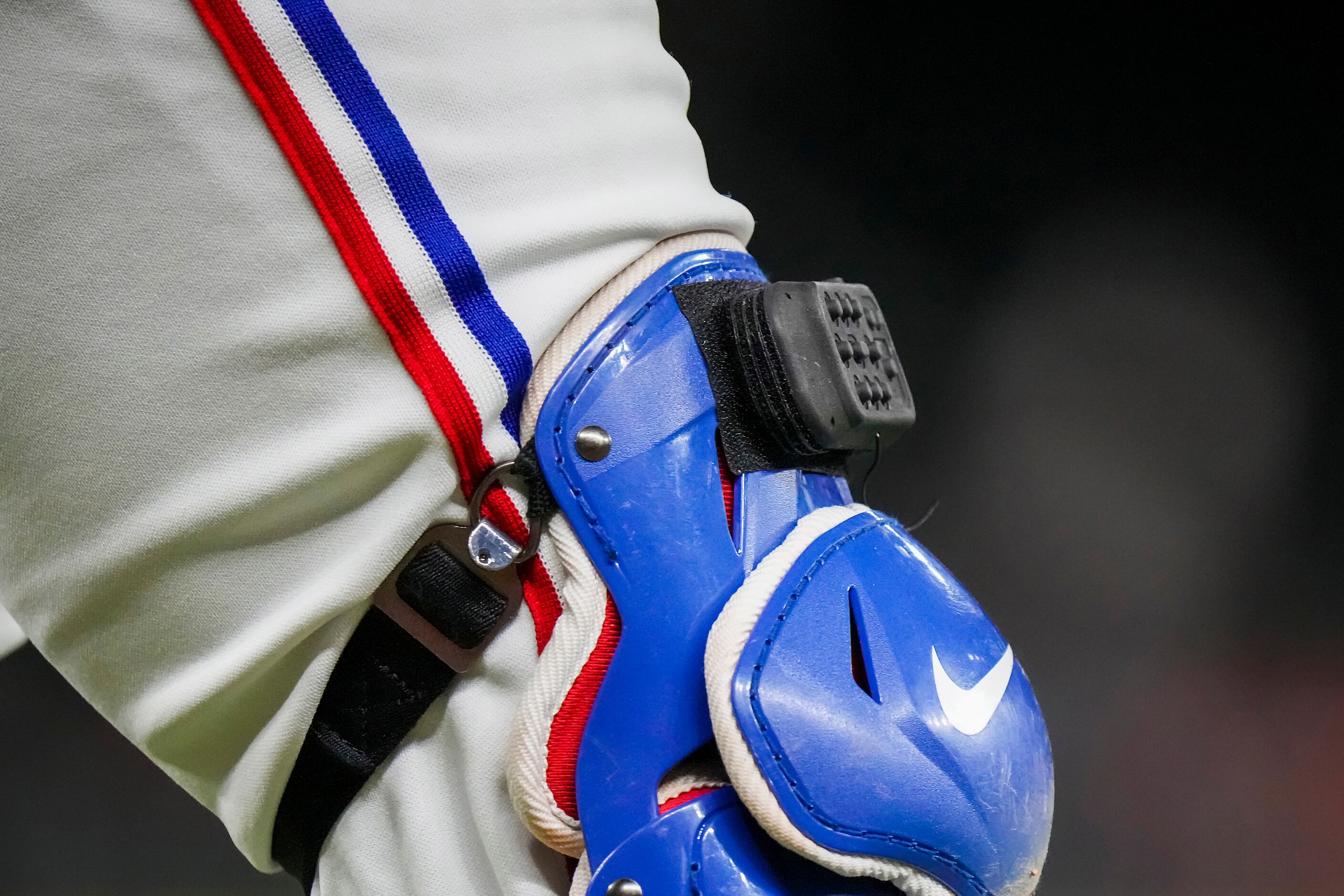 Texas Rangers catcher Mitch Garver wears a PitchCom device on his shin guards during an...