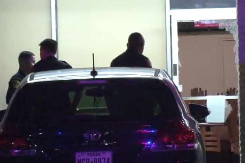 Houston police survey the scene at a restaurant that five to seven masked gunmen broke into...