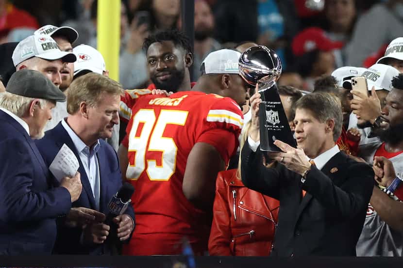 Clark Hunt raises the Super Bowl trophy after his Kansas City Chiefs won the NFL's...