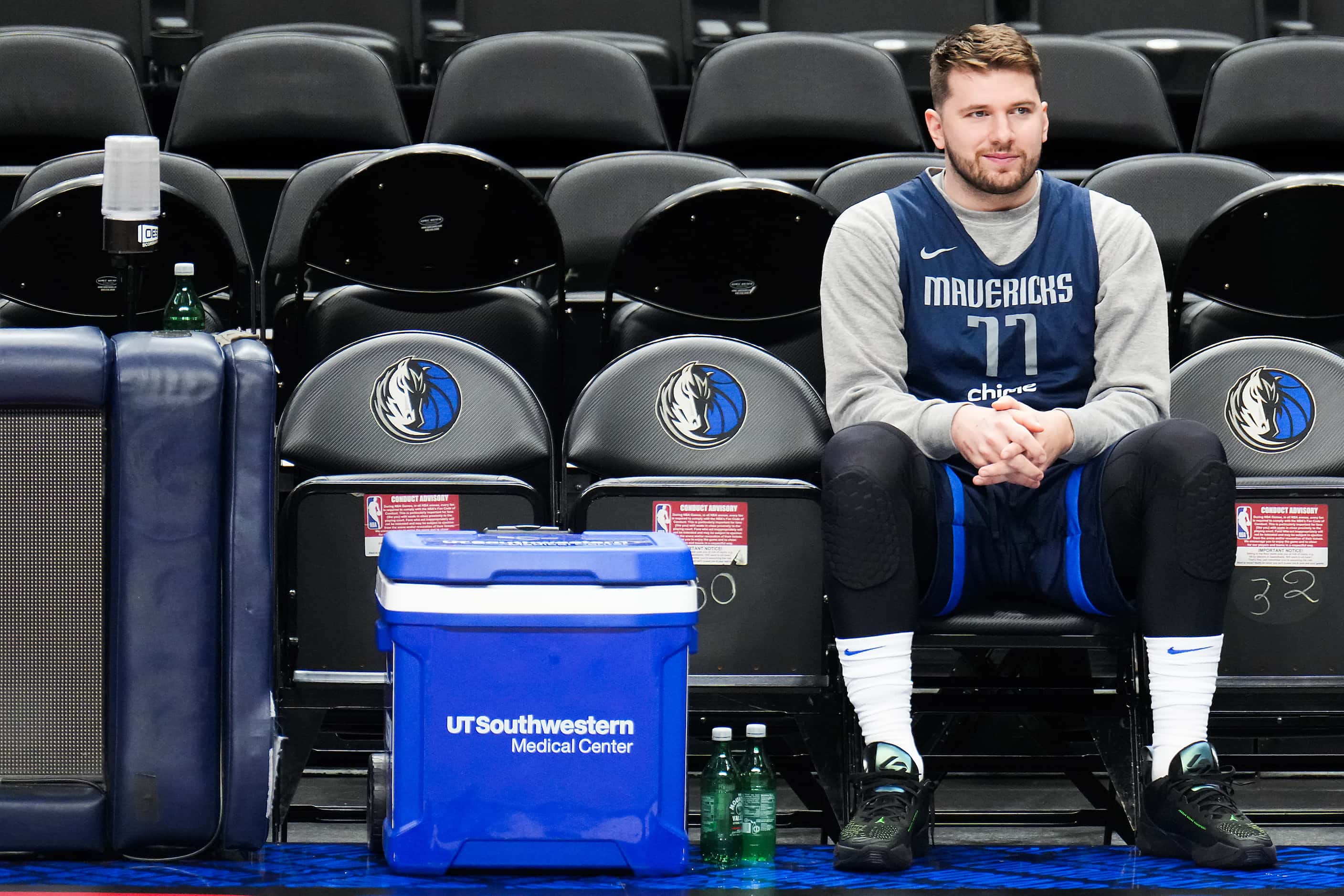 Dallas Mavericks guard Luka Doncic looks on from the bench during practice in preparation...