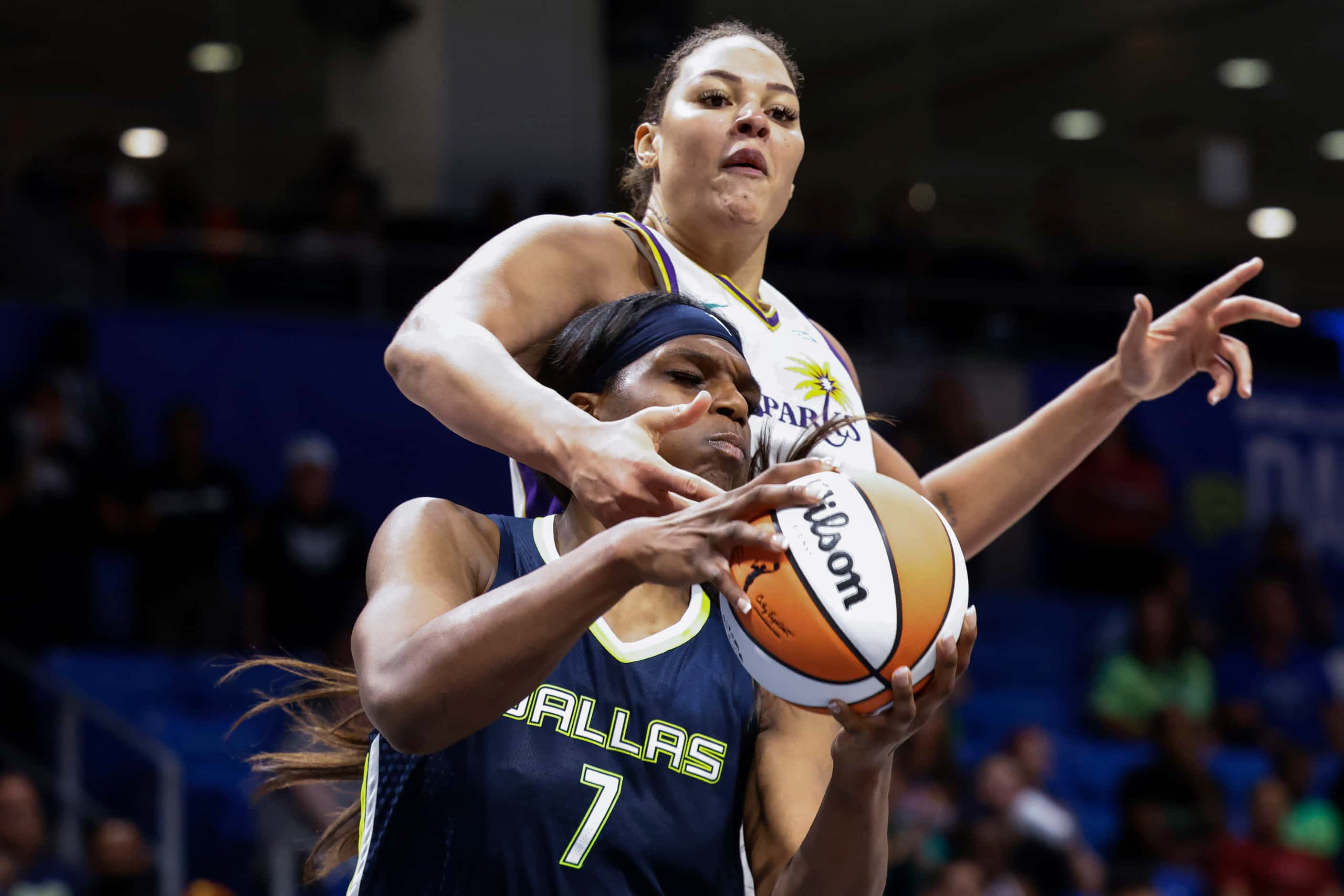 Los Angeles Sparks center Liz Cambage, back, defends against Dallas Wings center Teaira...