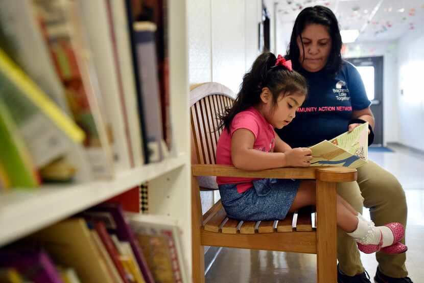 Patricia Vega works with her daughter Elizabeth Diaz on educational activities to help her...