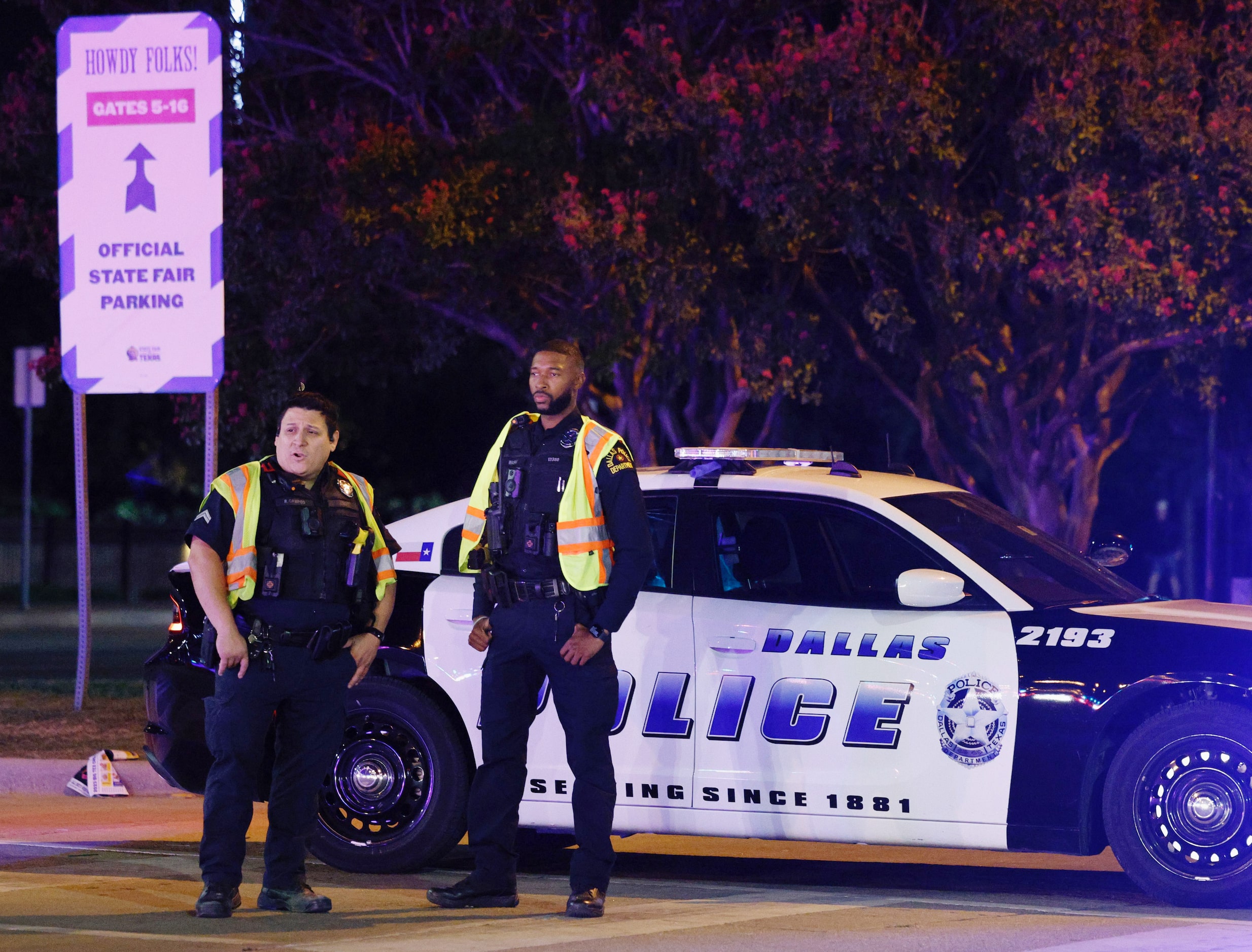 Dallas policemen stand guard after a shooting at the State Fair of Texas on Saturday night....