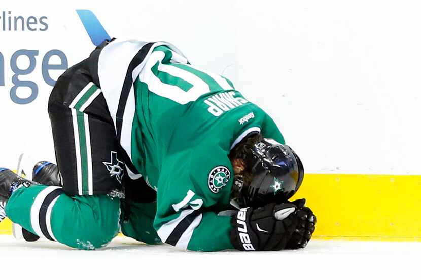 Dallas Stars left wing Patrick Sharp (10) lays on the ice after hitting his head on a check...