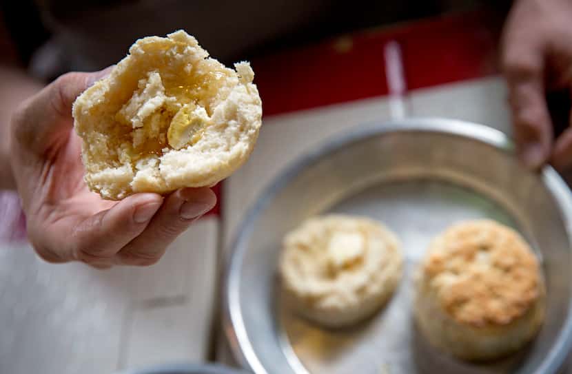 Chef Tim Byres adds honey butter to buttermilk biscuits at Chicken Scratch restaurant.