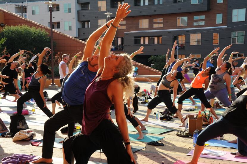 Yogis practice at the D-FW Free Day of Yoga Kickoff at the Latino Cultural Center in Dallas,...
