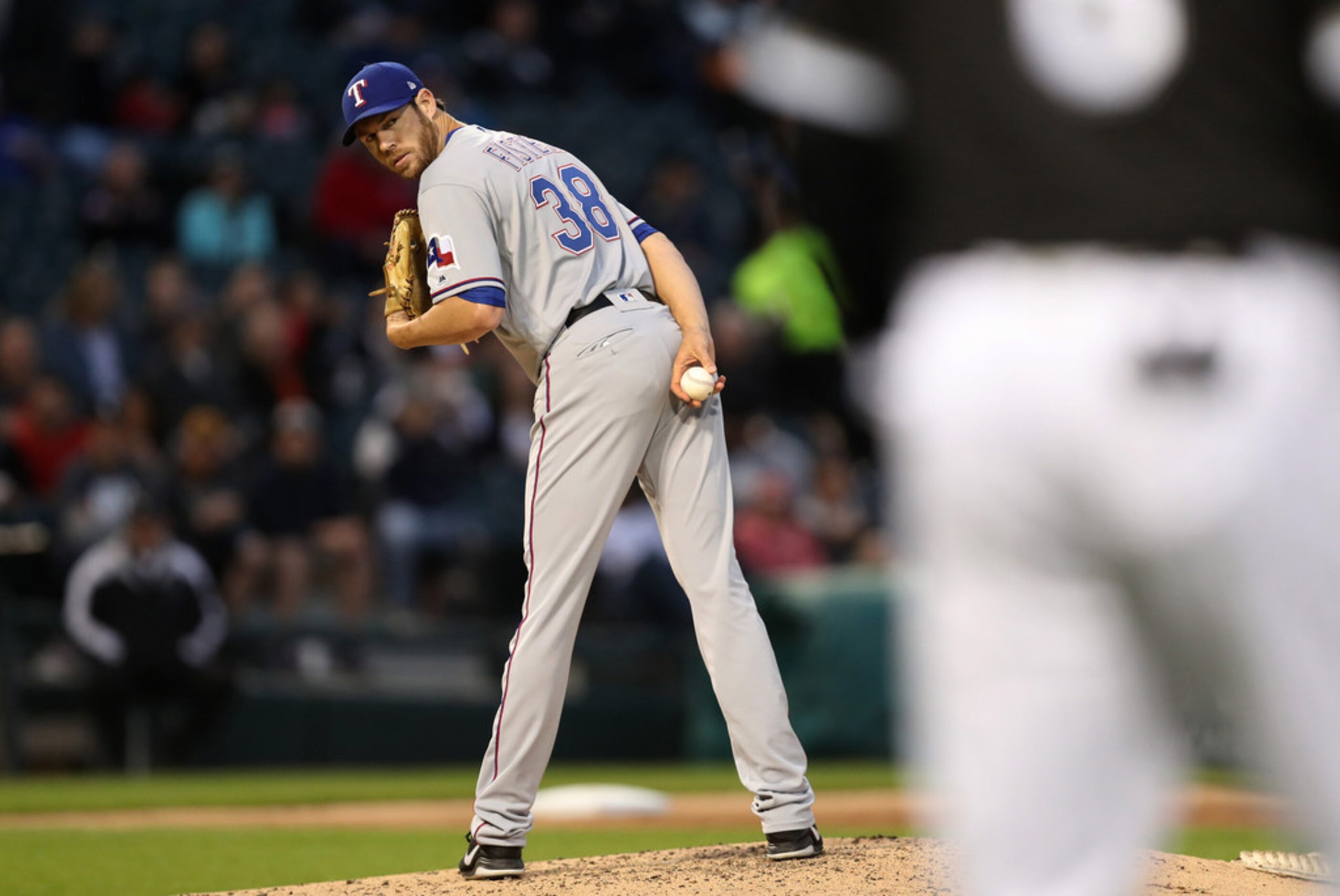 Texas Rangers starting pitcher Doug Fister (38) holds a Chicago White Sox runner on in the...