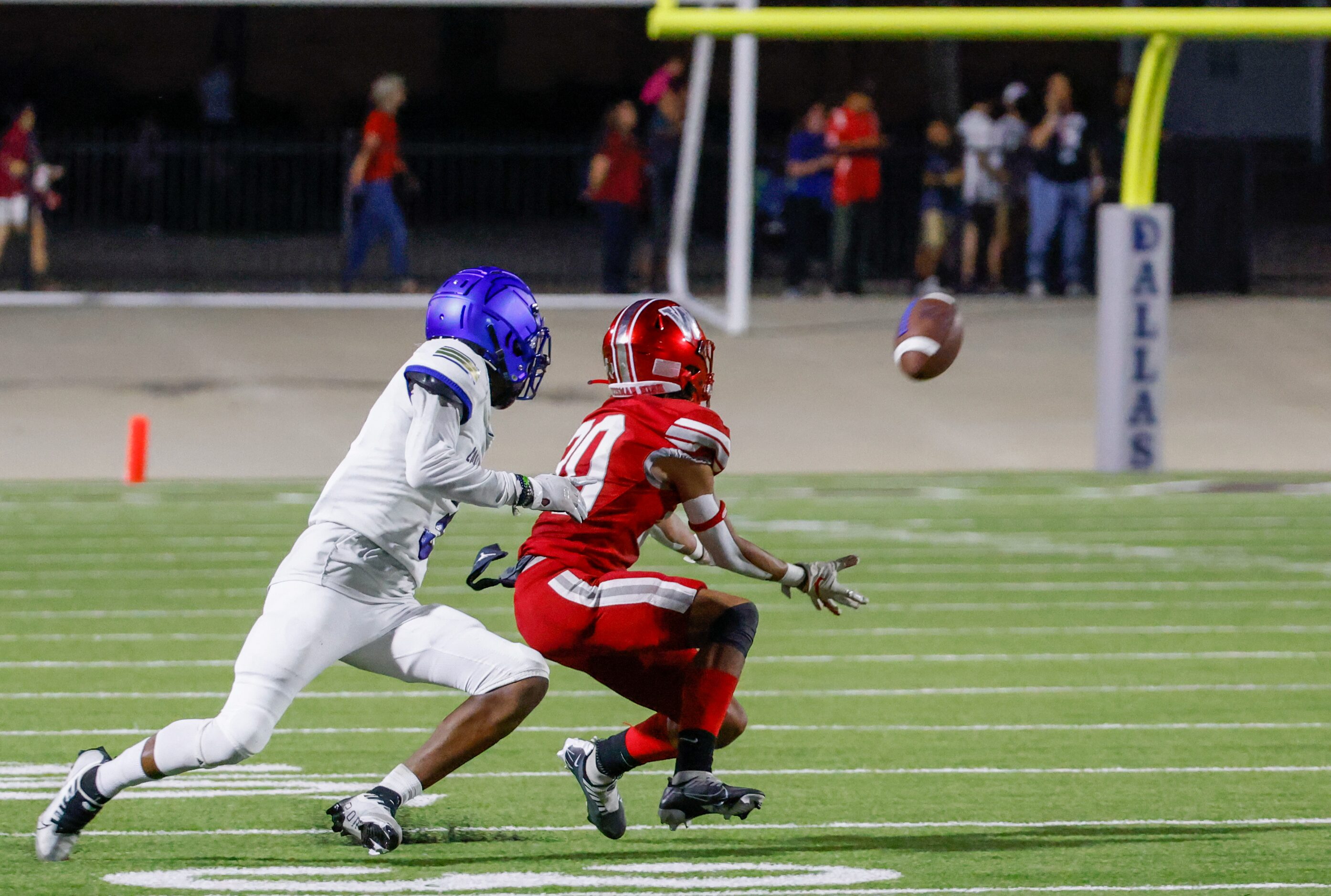 Woodrow Wilson defensive back Jamion Nash (20) blocks wide receiver DeAnthony Flagge (3)...