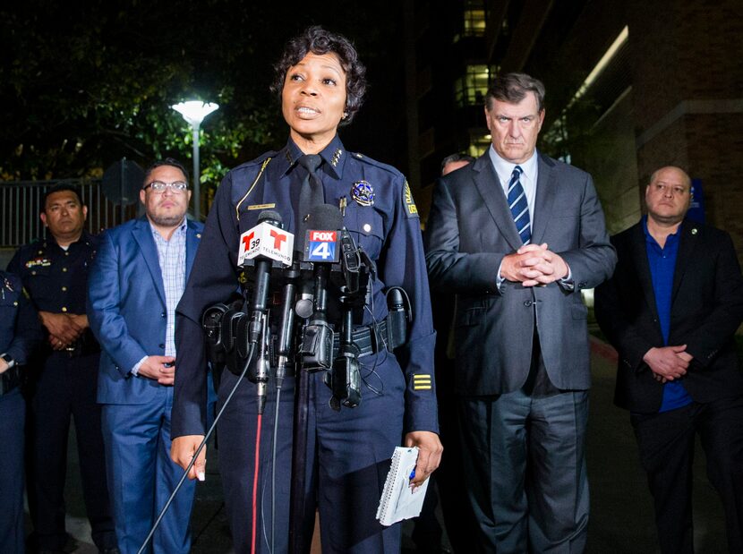 Dallas Mayor Mike Rawlings listens to Police Chief U. Renee Hall at a news conference...