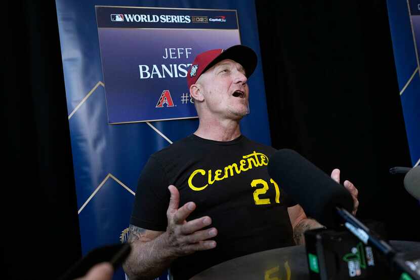 Arizona Diamondbacks' Jeff Banister, left, answers a question during a World Series baseball...