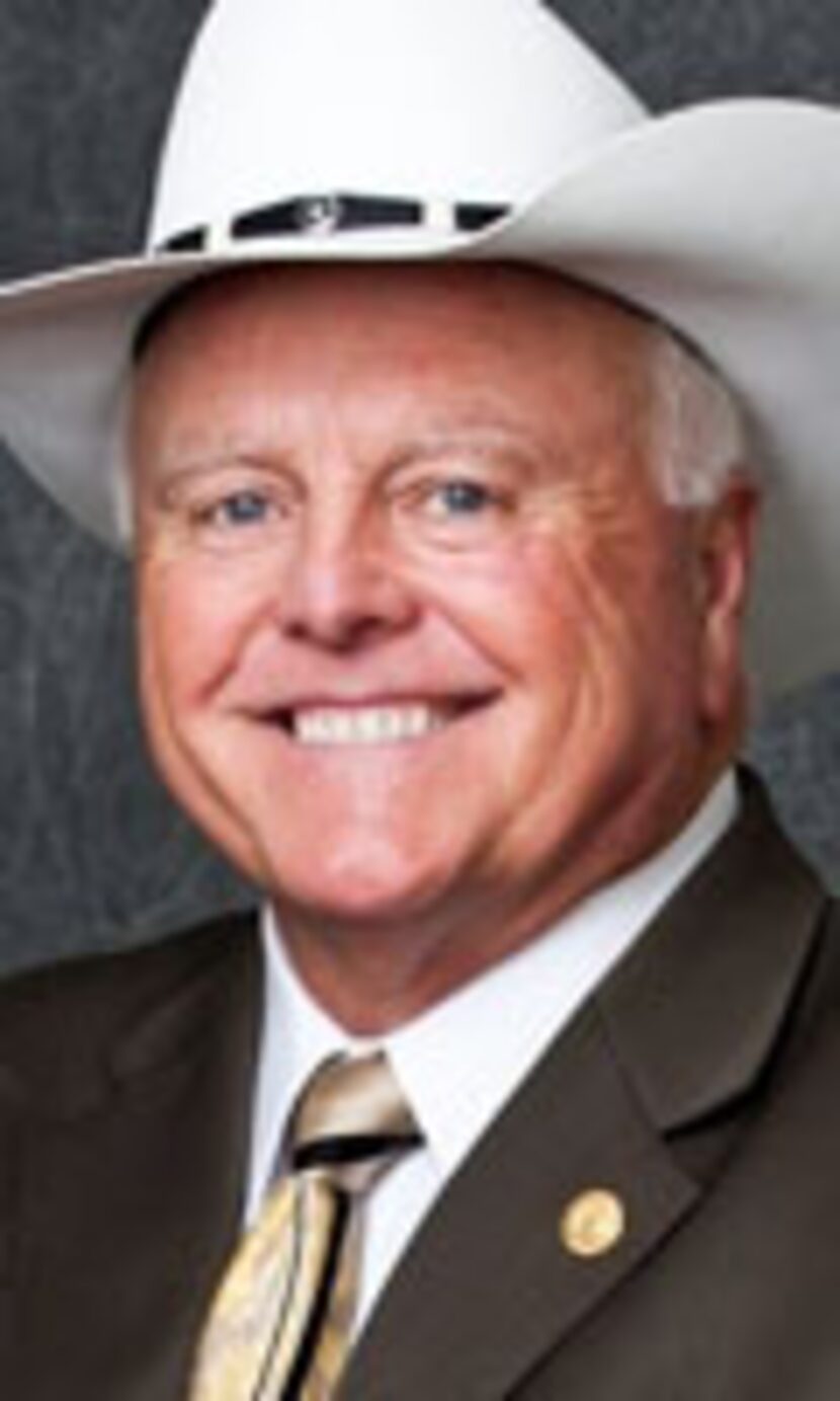 
Agriculture Commissioner Sid Miller holds his cowboy hat over his heart during the singing...