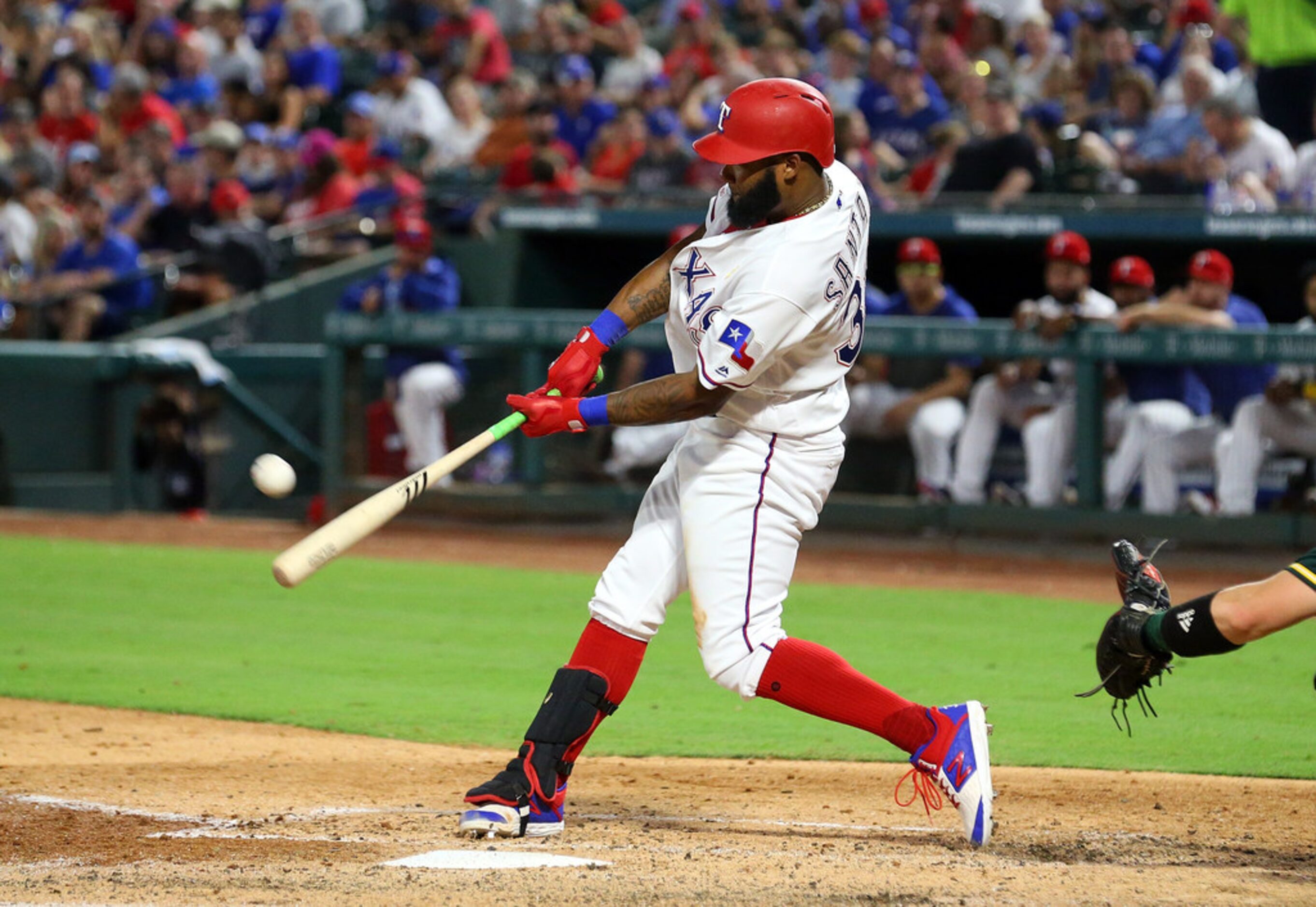 ARLINGTON, TEXAS - SEPTEMBER 13: Danny Santana #38 of the Texas Rangers hits a three run...