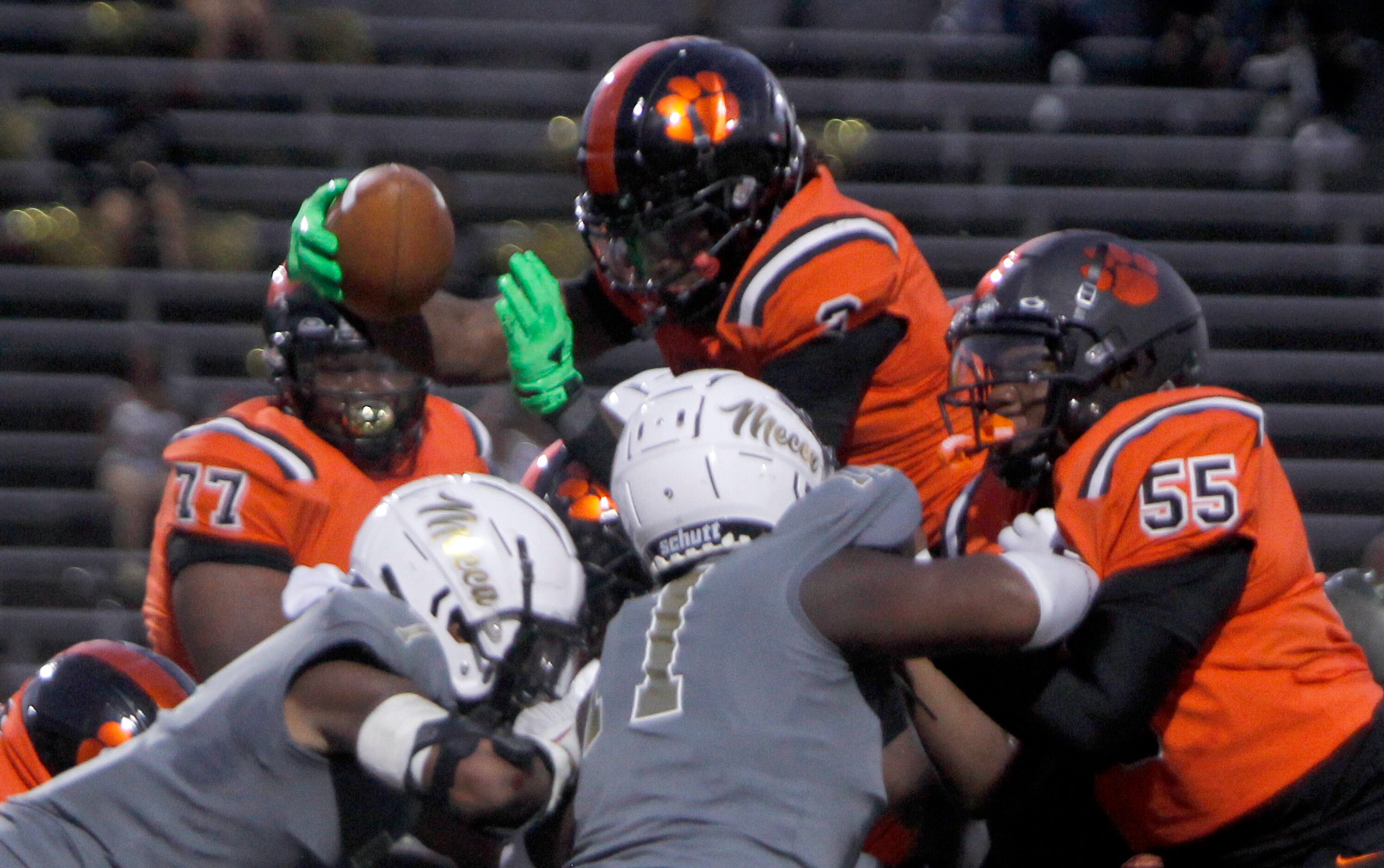 Lancaster running back Kewan Lacy (2) goes up and over the top of two South Oak Cliff...