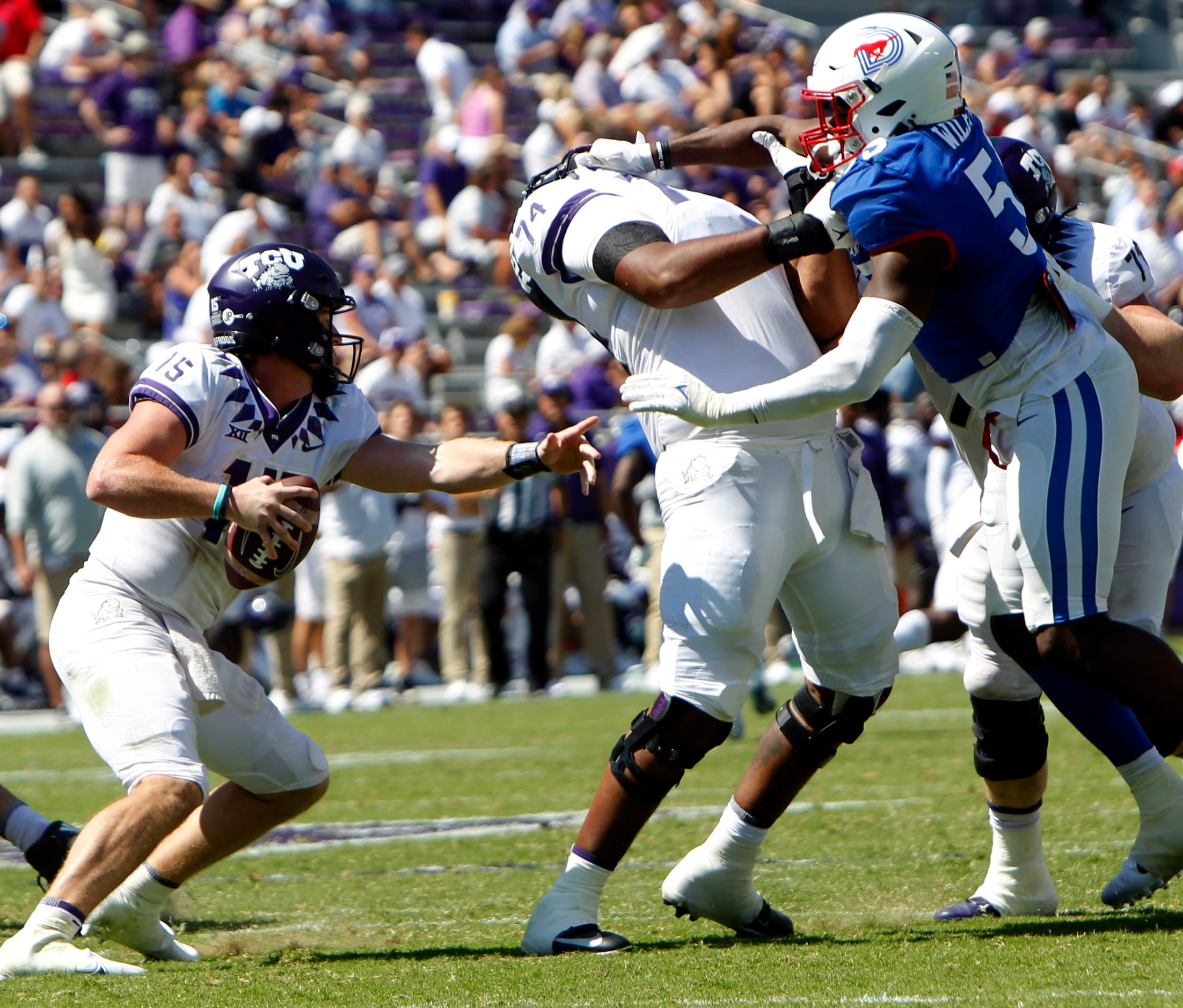 TCU quarterback Max Duggan (15), left, maneuvers around the block of offensive lineman...