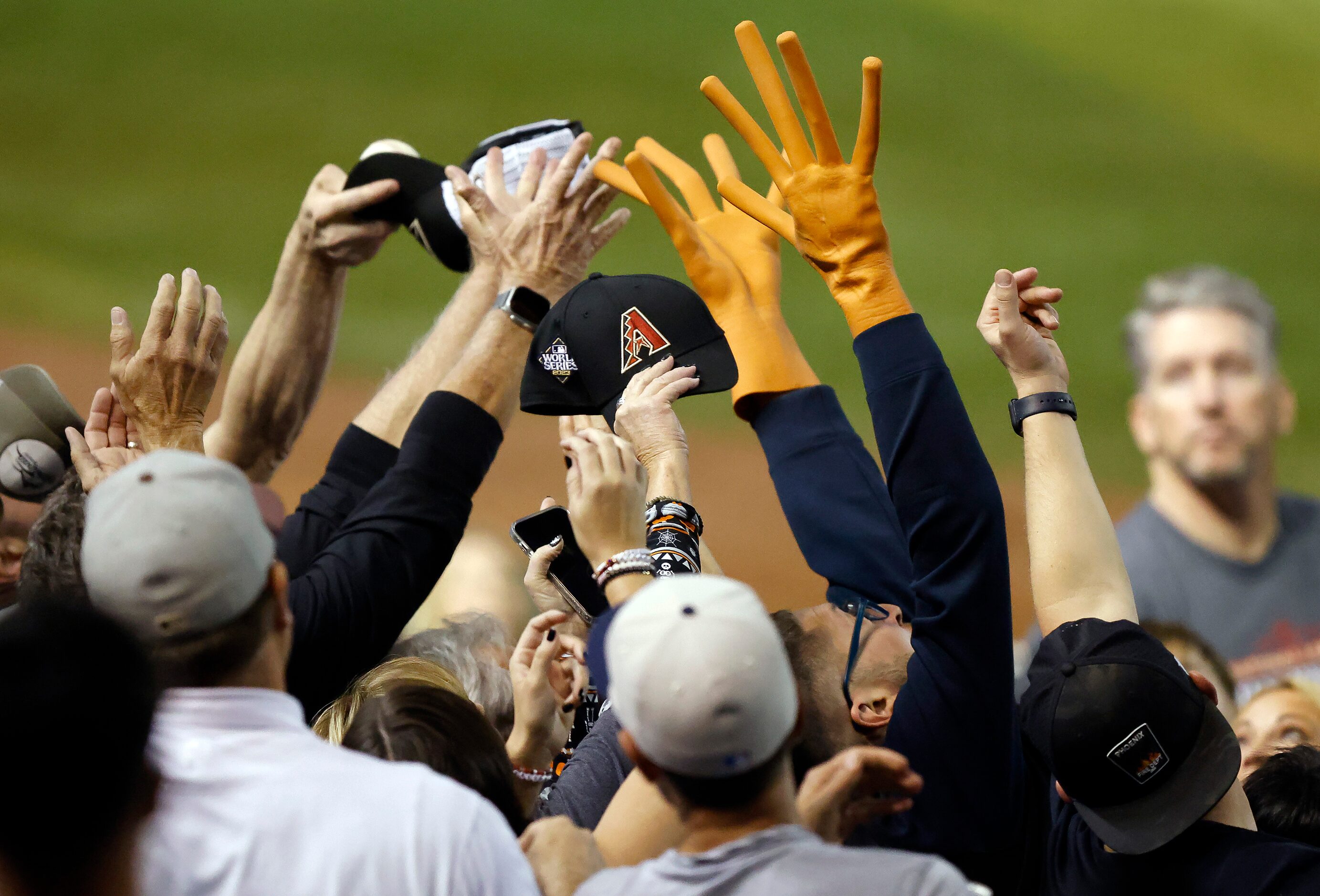 Fans clamor for a foul ball during the sixth inning in Game 4 of the World Series between...