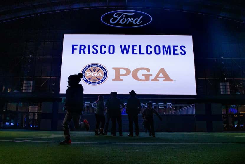 Visitors played on the field as a message welcoming the PGA of America to Frisco lit up at...