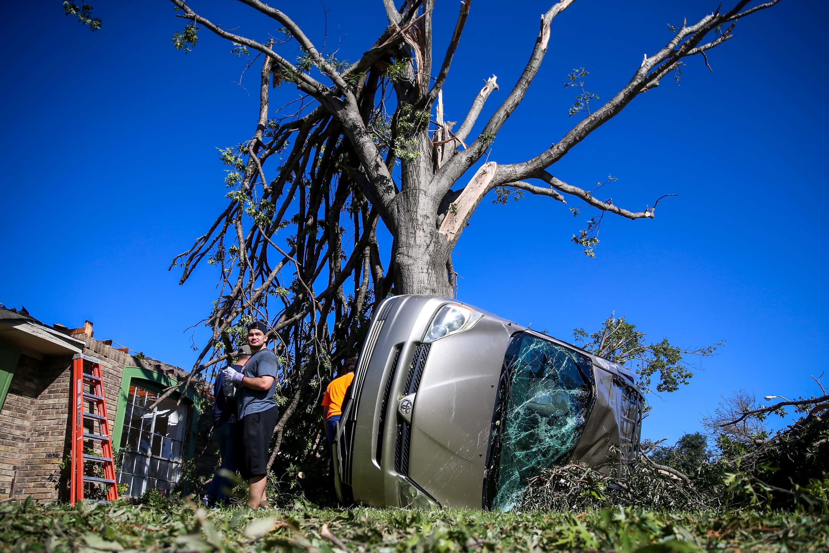 Members of Texas Baptist Men and Islamic Relief USA clear tornado debris on Monday, October...