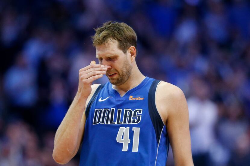 Dallas Mavericks forward Dirk Nowitzki (41) gets emotional after a video played during a...