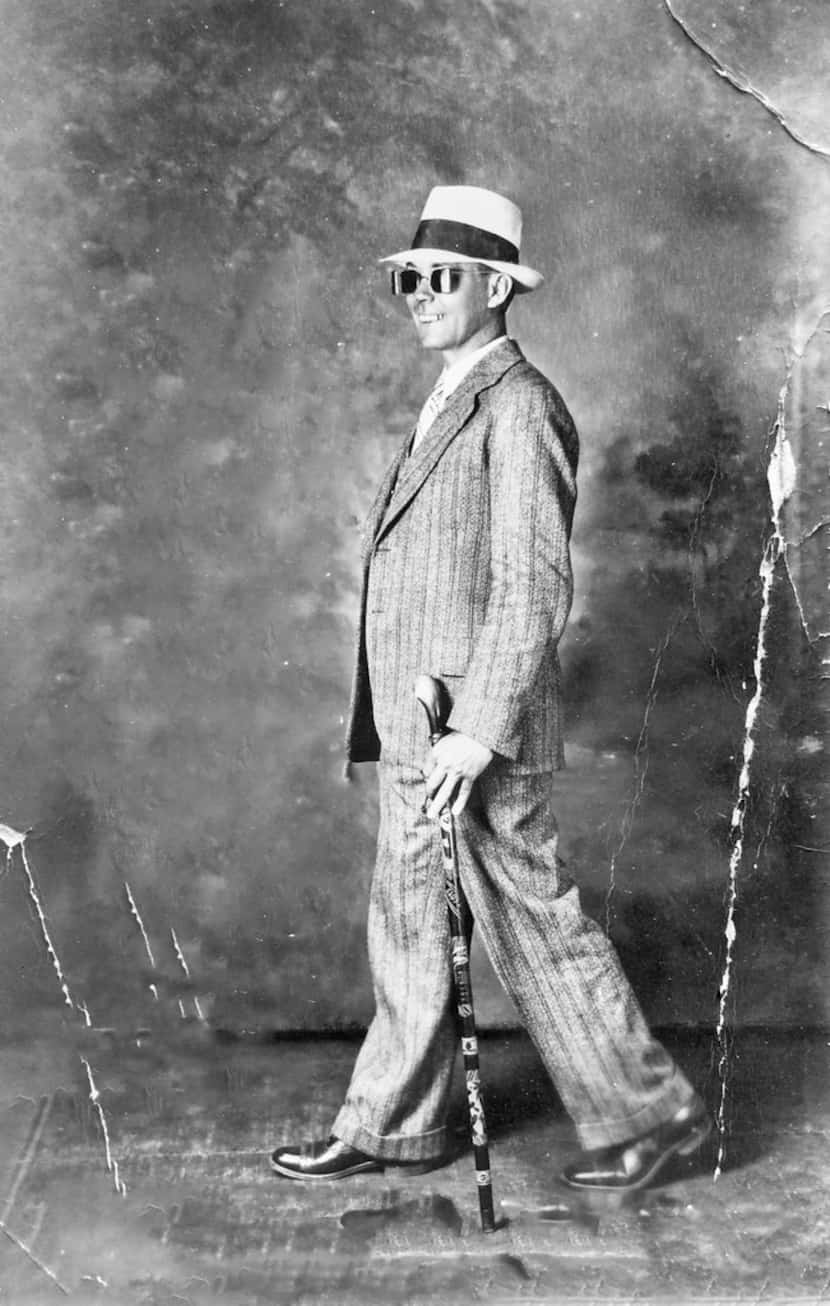 A photo of Plennie Wingo, taken in April 1931, in Dallas, shows him walking backward wearing...