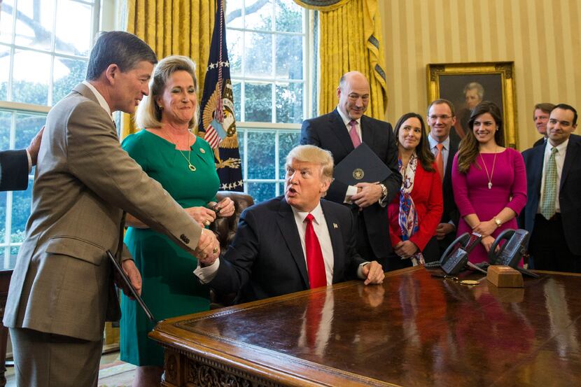 President Donald Trump shakes hands with Rep. Jeb Hensarling, R-Dallas, alongside Rep. Ann...