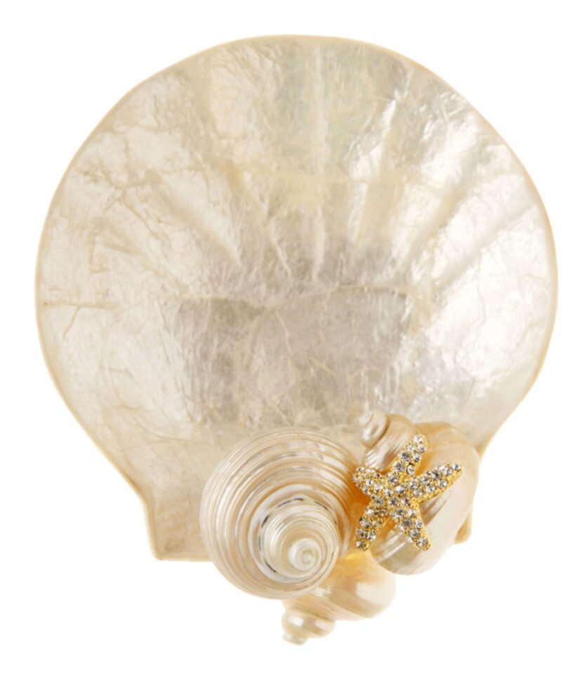 Shell game: A luminous capiz trinket holder accented with genuine seashells accessorizes the...