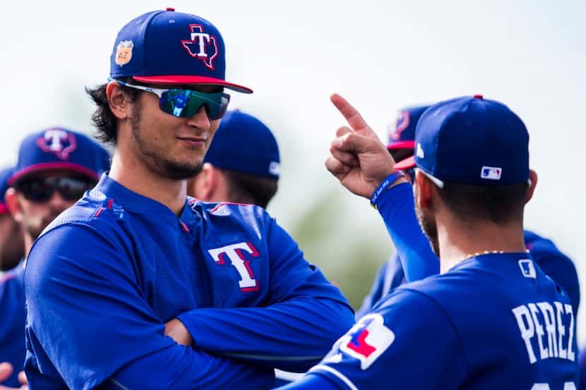 Texas Rangers starting pitcher Yu Darvish (11) reacts to starting pitcher Martin Perez (33)...