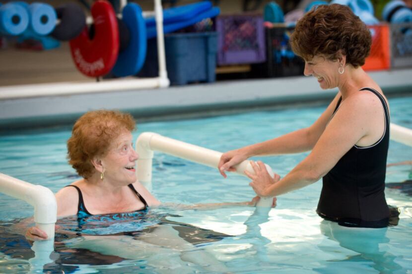 Maria Zakich, right, ihas a laugh with her mom, Grace Rousset, 86, while exercising at the...