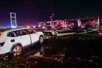 A Volkswagen SUV is seen in a ditch near a Shell gas station after a suspected tornado...