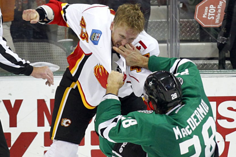 The Stars' Krys Barch connects on a punch against San Jose's Jim Vandermeer in the second...