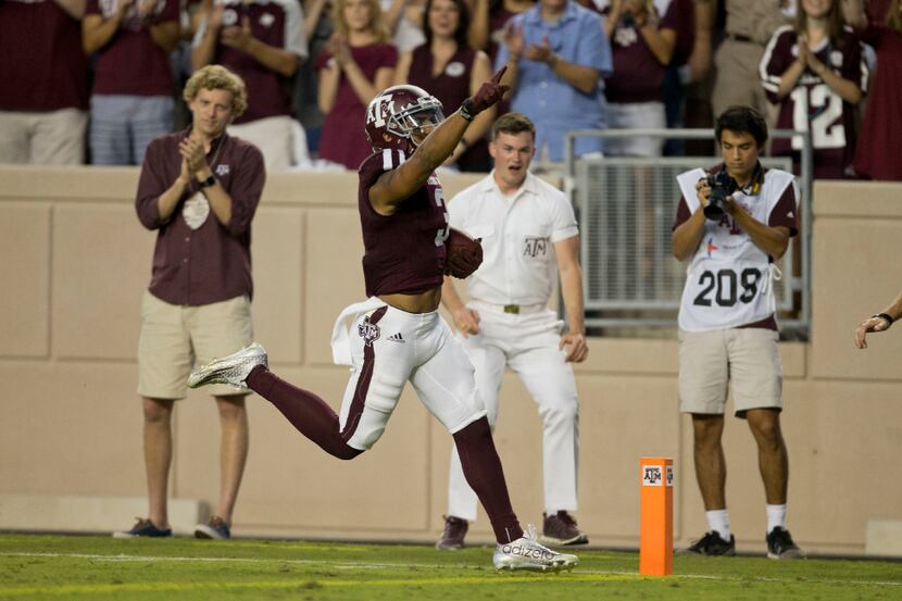 Texas A&M's Christian Kirk (3) crosses the goal line for a touchdown after returning a punt...