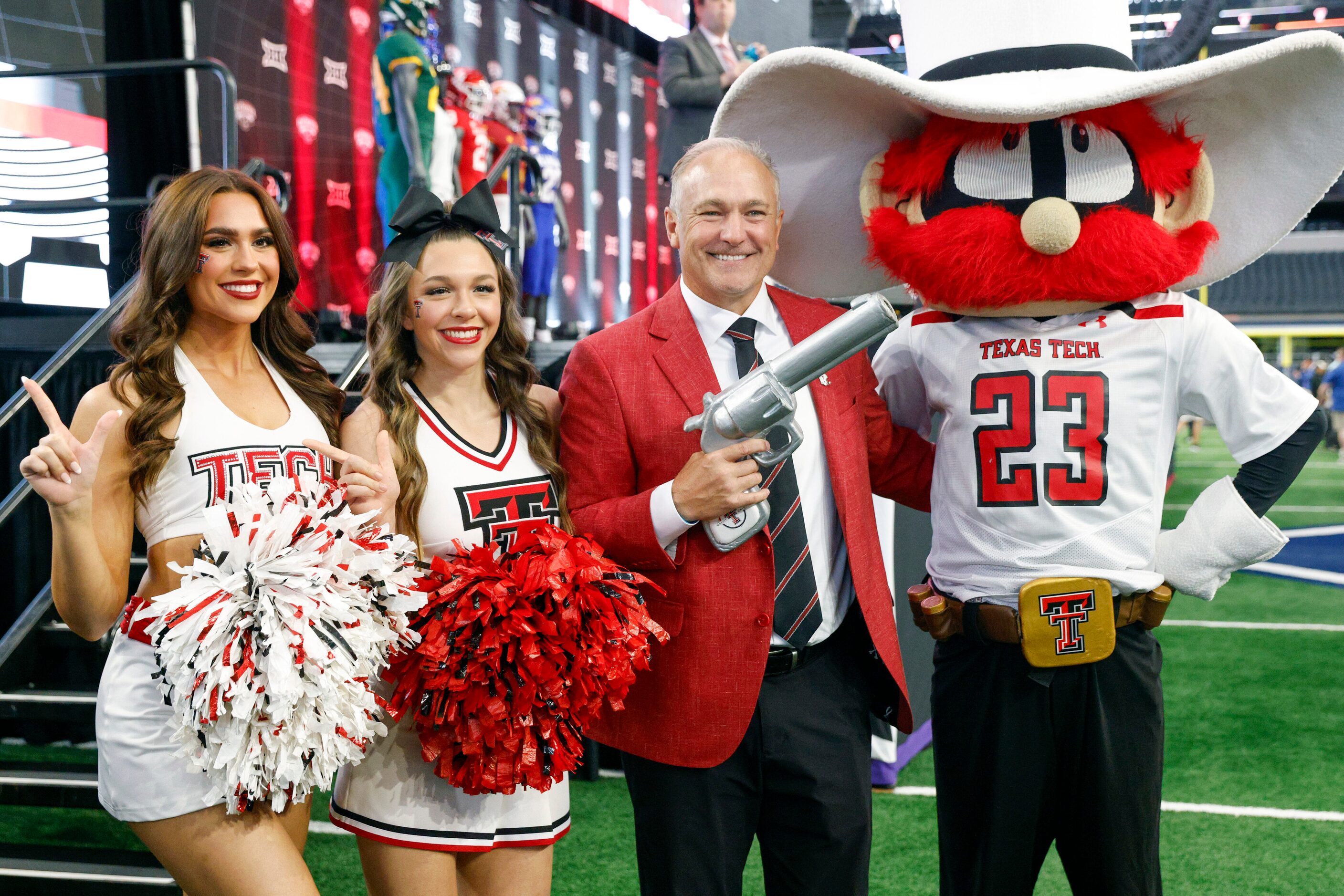 Texas Tech head coach Joey McGuire poses for a photo with cheerleaders and Texas Tech mascot...