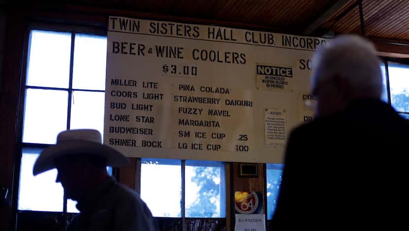 In this Dec. 6, 2014, photo, a menu hangs in the bar area at Twin Sisters Dance Hall in...
