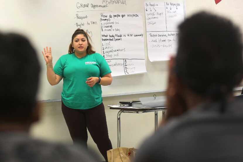 Amanda Mendoza talks with students during a sex education class for kids in Vickery Meadow,...