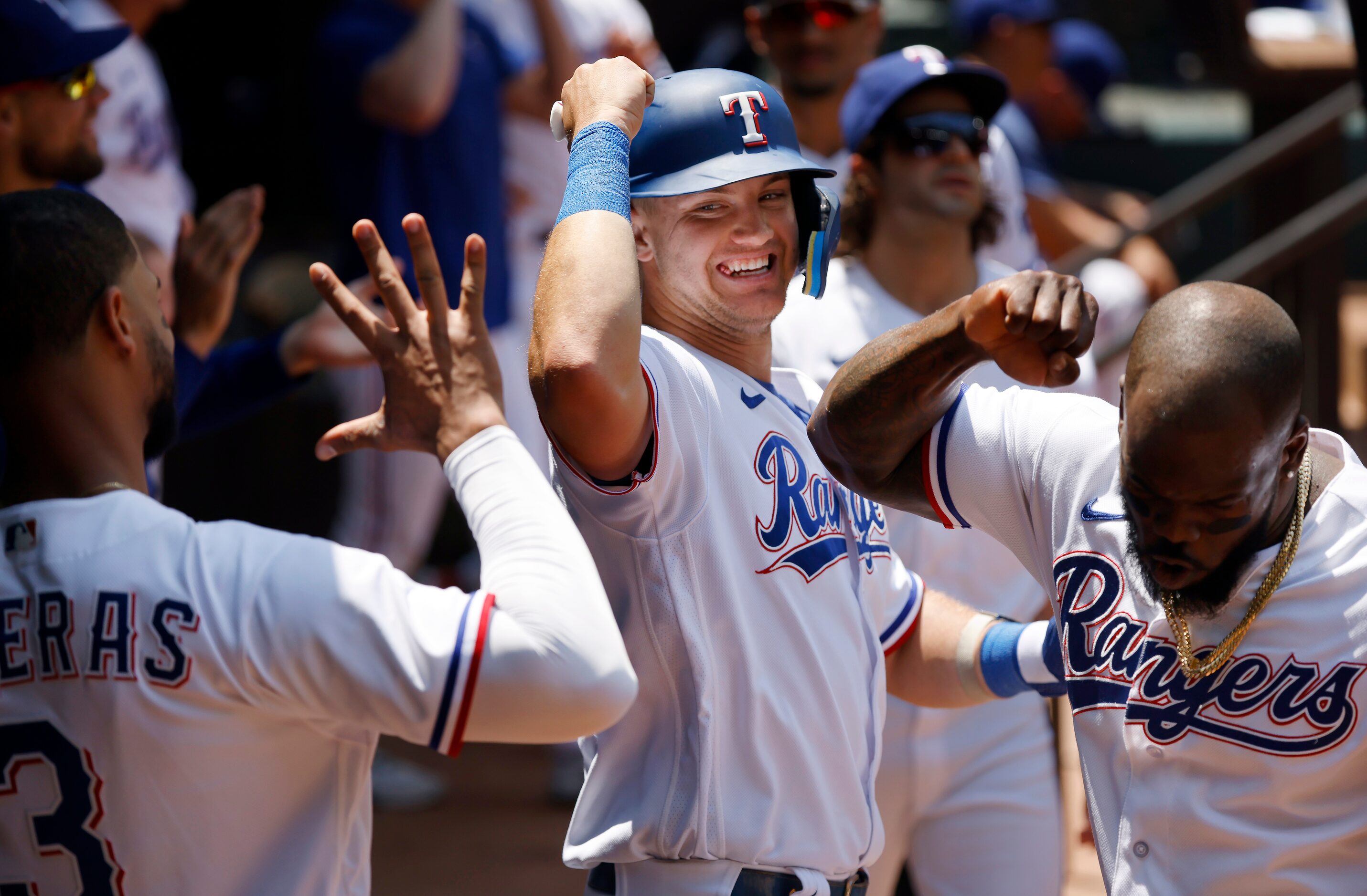 Texas Rangers Josh Jung (center) is congratulated by teammates Adolis Garcia (right) and...