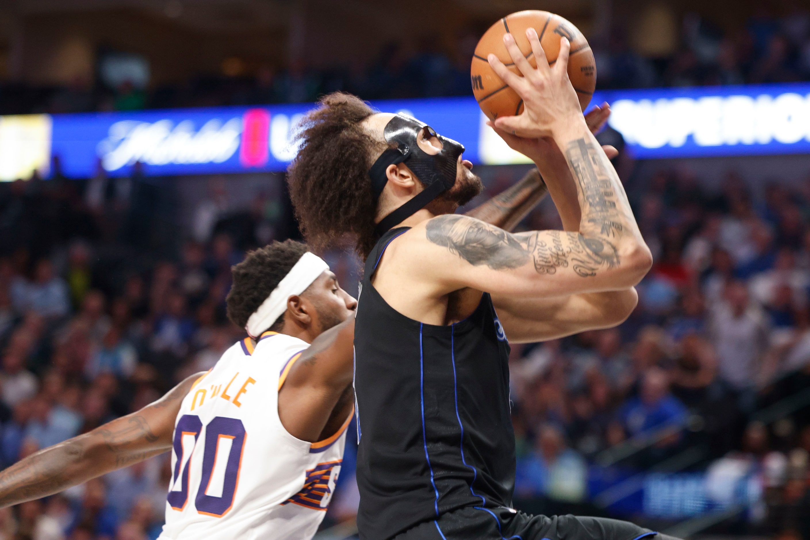 Dallas Mavericks' Dereck Lively II (right) drives to the basket past Phoenix Suns forward...