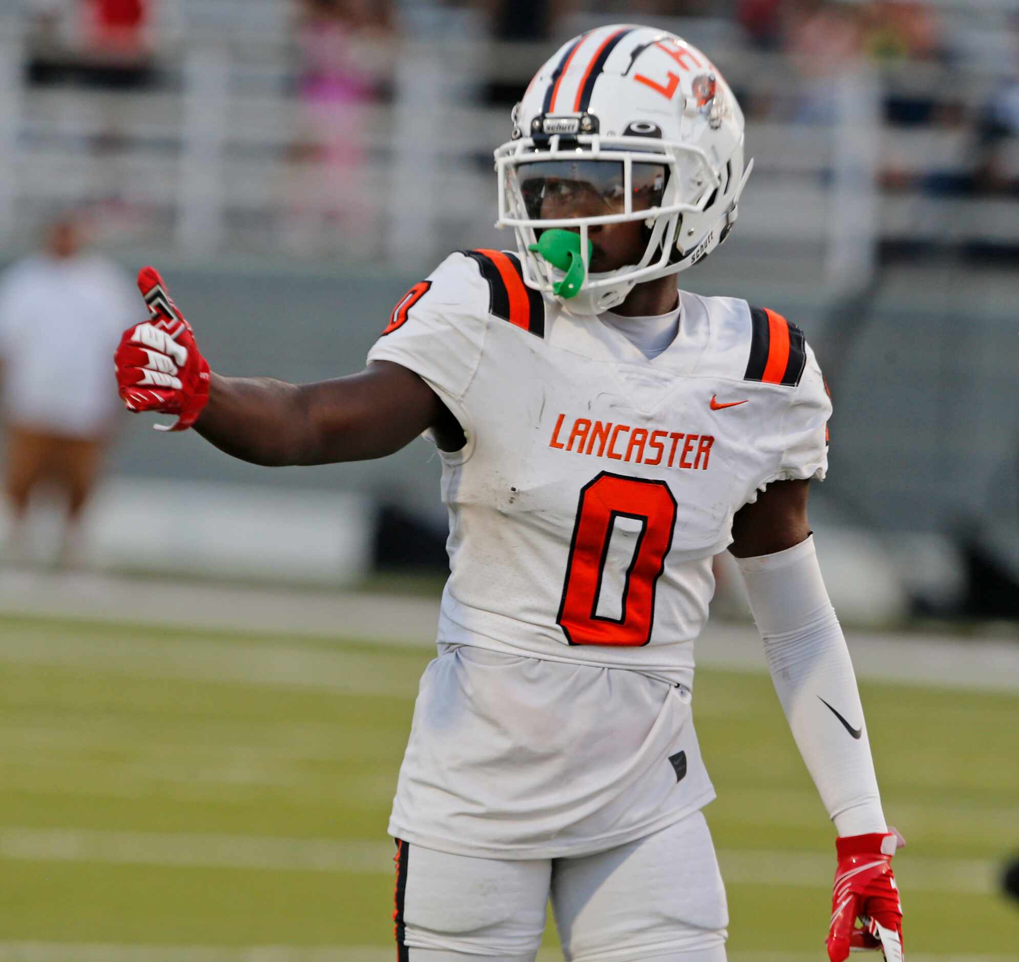 Lancaster’s Ti’Erick Martin (0) gives a thumbs up signal during the first half of a high...