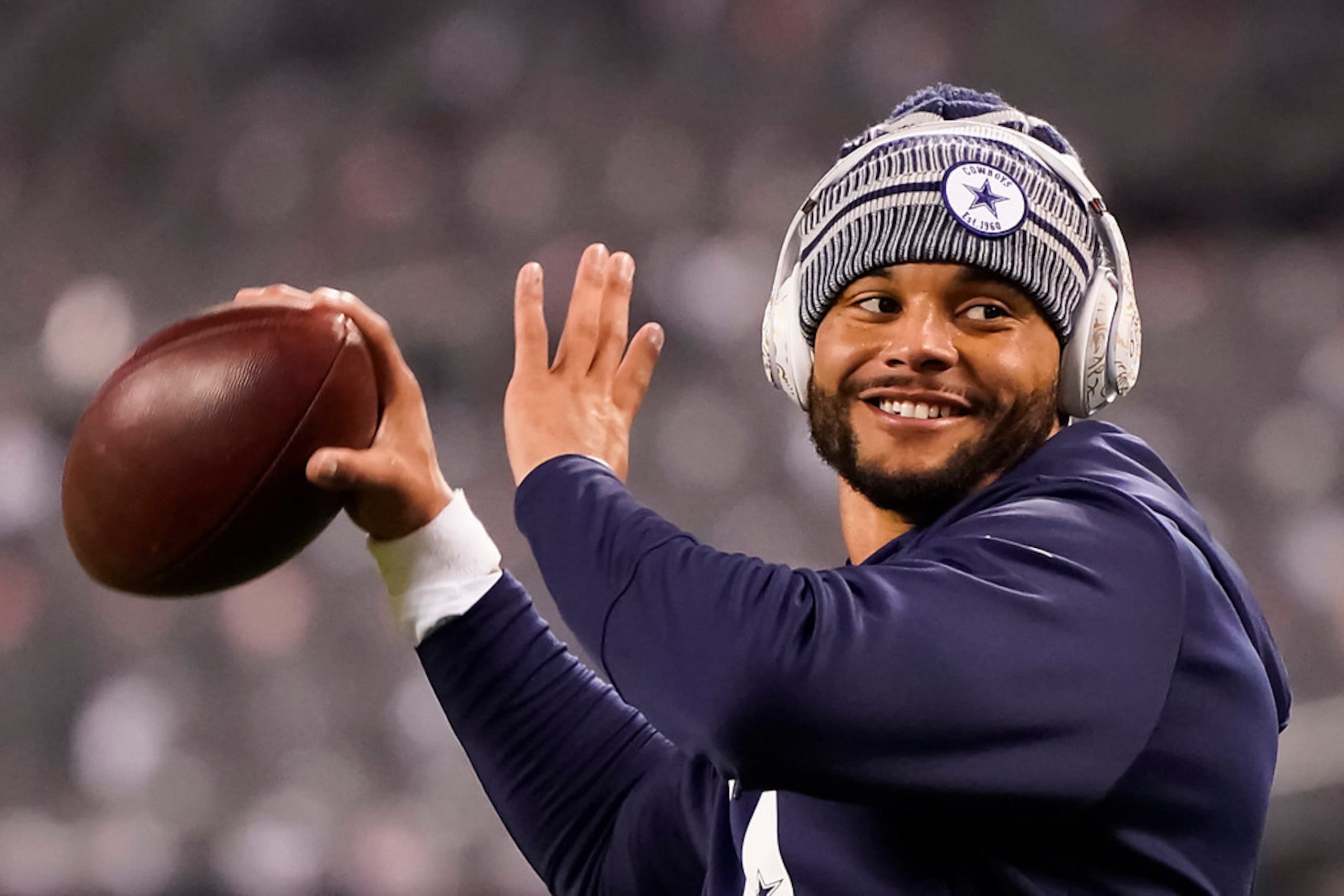 Dallas Cowboys quarterback Dak Prescott warms up before an NFL football game against the...