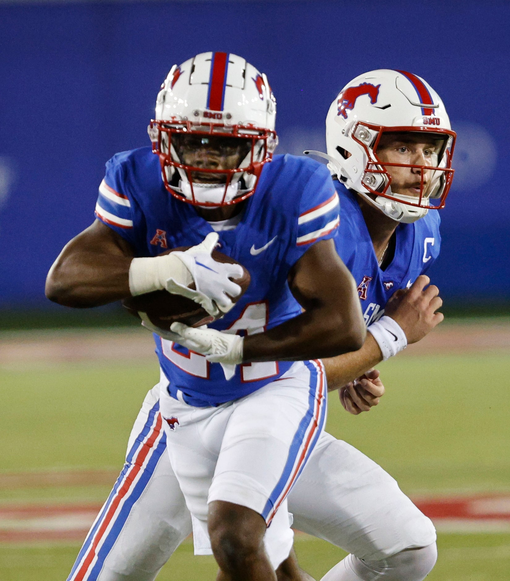 SMU running back Velton Gardner (24), left, carries the ball after SMU quarterback Preston...