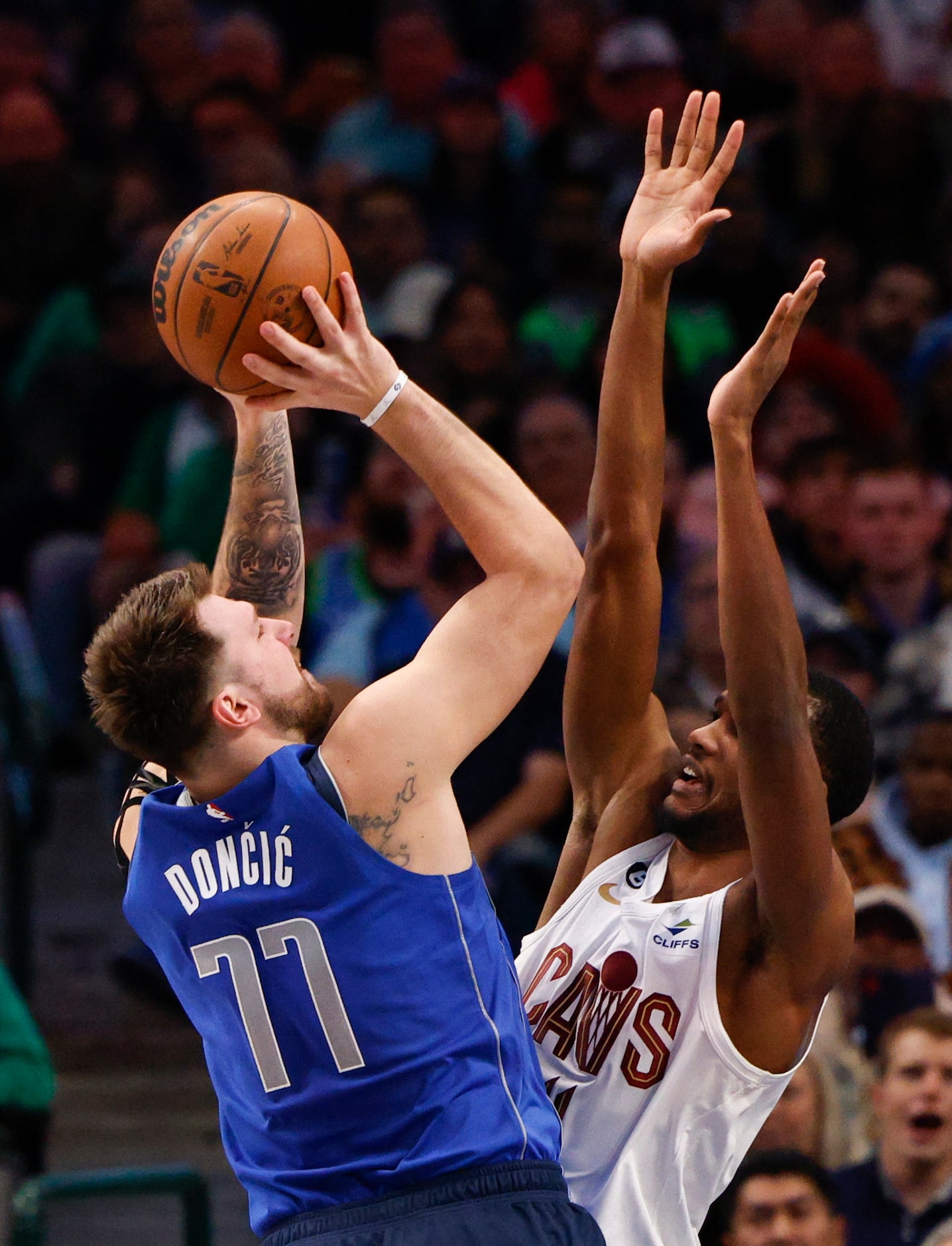 Cleveland Cavaliers forward Evan Mobley (4) fouls Dallas Mavericks guard Luka Doncic (77) as...