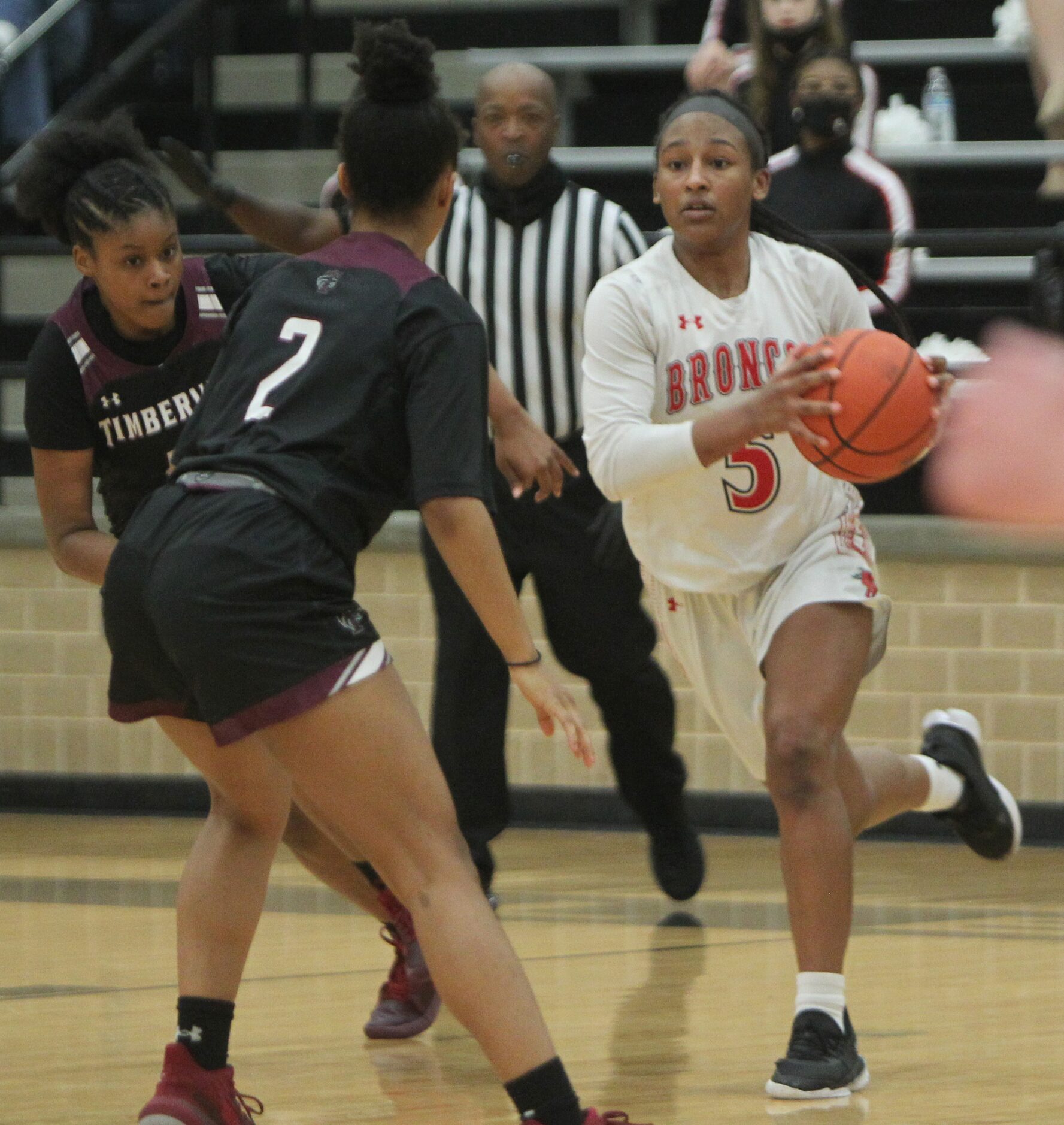 Mansfield Legacy guard Savannah Catalon (5) eyes the defense of Mansfield Timberview's...