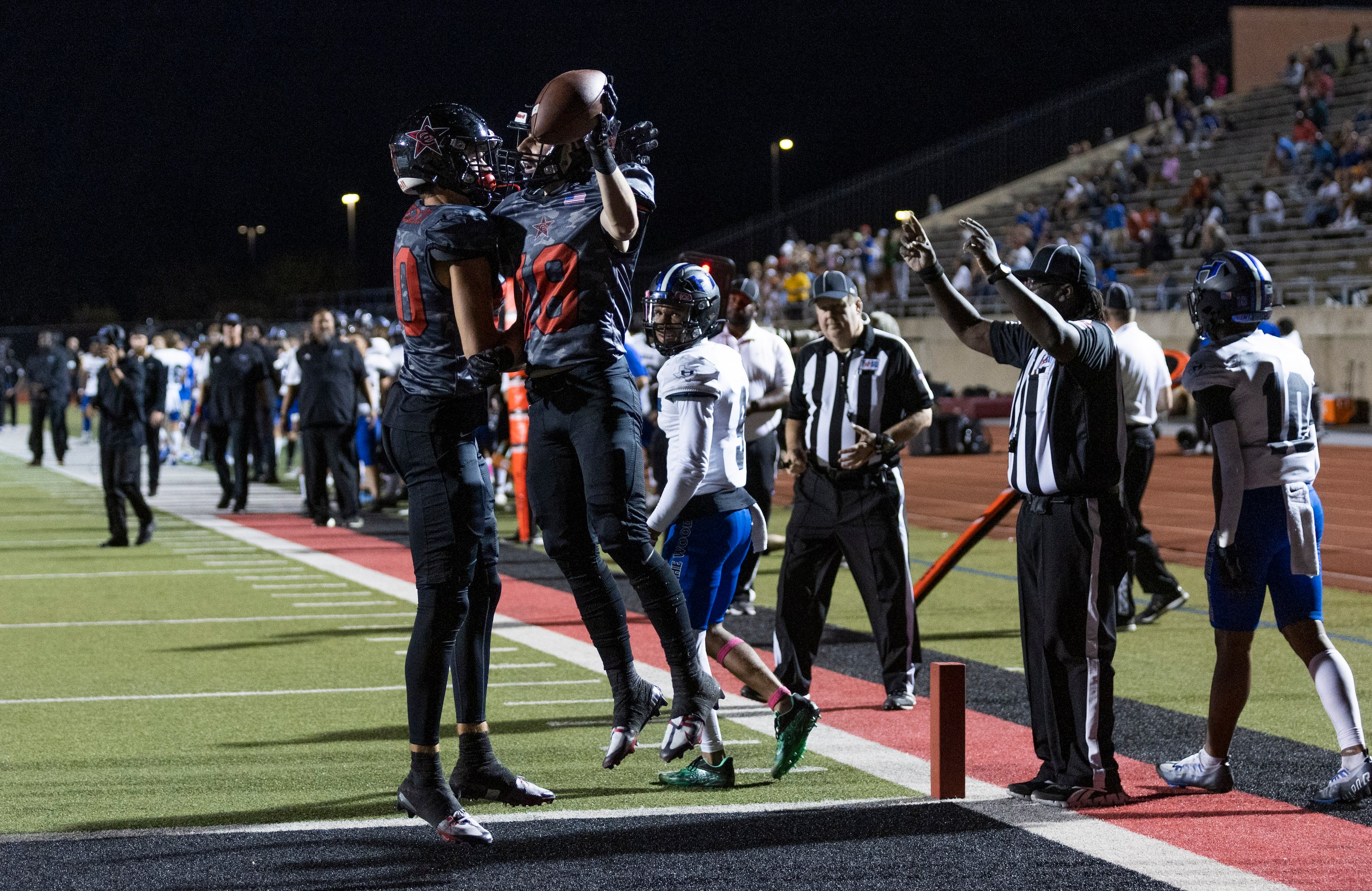 Coppell senior wide receiver Zack Darkoch (18) is congratulated by junior wide receiver...